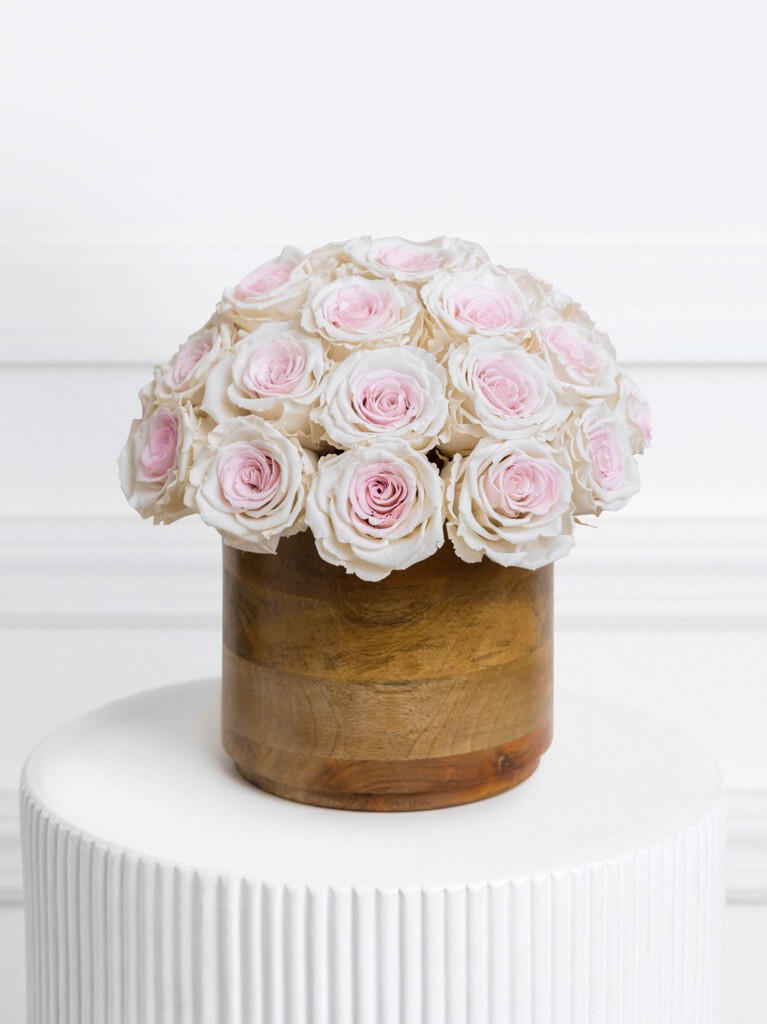 An elegant 30-stem preserved rose arrangement in warm peach and cream hues, styled in a dark wood vase for a luxurious, long-lasting gift that’s perfect for anniversaries, milestones, or simply elevating your space all year long.